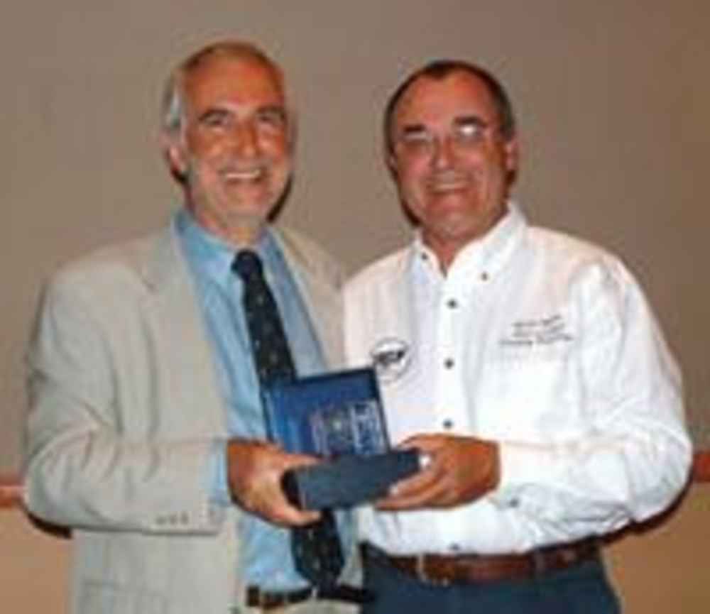 Dr Ian Dunbar receives his award from Martin Deeley